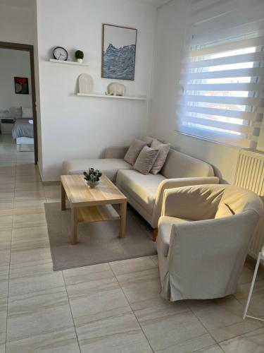 a living room with a couch and a coffee table at ArtStay-Apartment in Orestiada