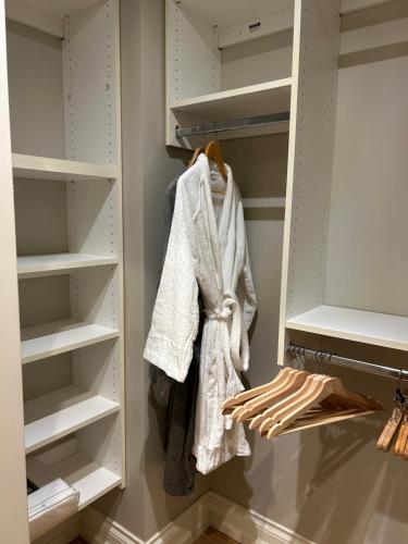 a walk in closet with white shelves and towels at Ride and Climb Lodge in Squamish