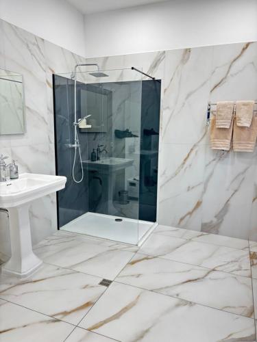 a bathroom with a shower and a sink at Experiencebruges in Bruges