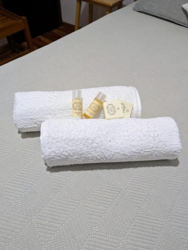 two white towels on a bed with at Residencial Borges in Condeixa a Nova