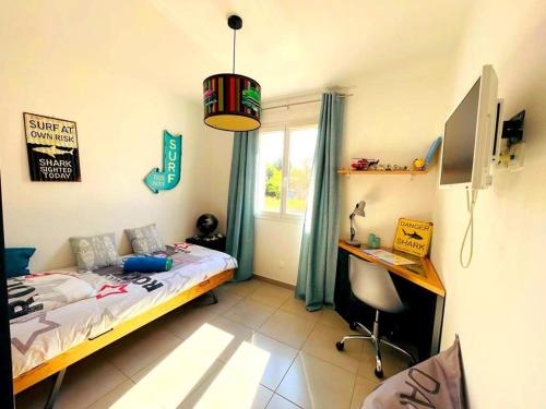 a bedroom with a bed and a desk and a window at Vila paradise in Ollioules