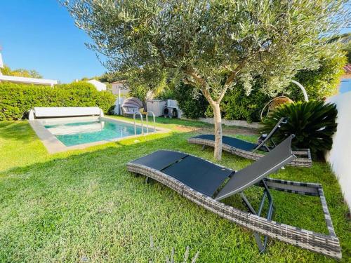 a pool with a slide next to a tree at Vila paradise in Ollioules
