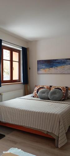 a bedroom with a large bed with two pillows at Garsonka u pivovaru, centrum Rožnov in Rožnov pod Radhoštěm