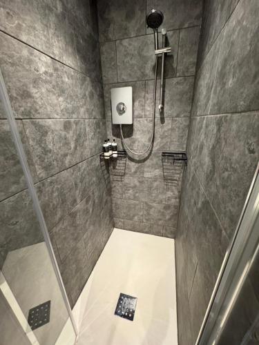 a bathroom with a shower with a shower at Crannaig House in Aberfoyle