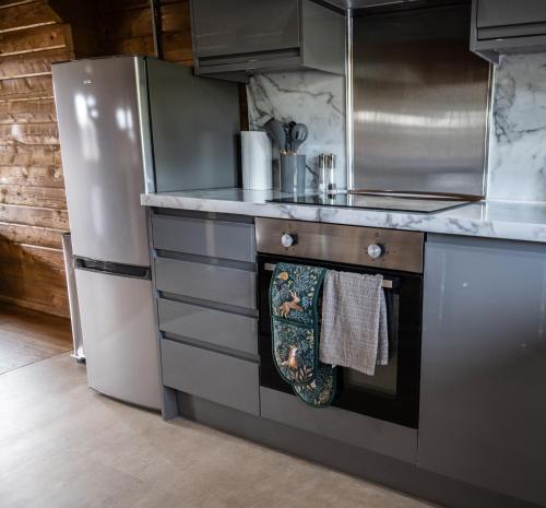 a kitchen with a stove and a refrigerator at Buzzards Retreat in Larling