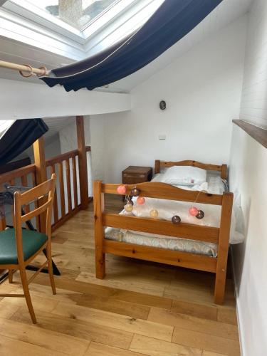 a small bedroom with a bed and a skylight at La Maison du Patou in Cadéac