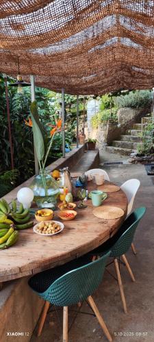 a wooden table with fruits and vegetables on it at Casa de basalto in Caniço