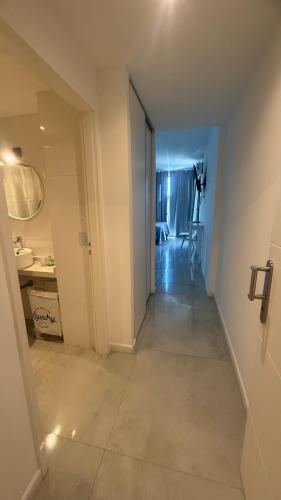 a hallway leading to a room with a table and a room at Brickell 6SIX in Tigre