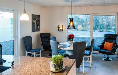 a dining room with a table and chairs at Awesome Home In Ringkøbing With Wifi in Ringkøbing