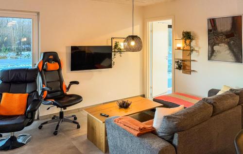 a living room with a couch and a chair at Awesome Home In Ringkøbing With Wifi in Ringkøbing