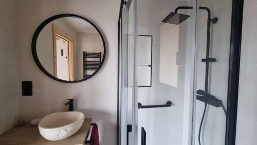 a bathroom with a large mirror and a sink at Cal Rocamartí, Turisme Rural - Montant de Tost, Pirineu in Montant