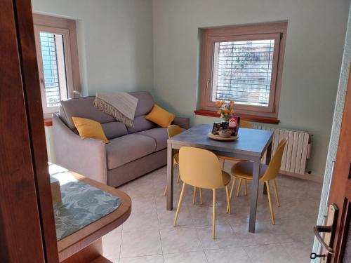 a living room with a table and a couch at Bella Vista casa vacanze in Grosio