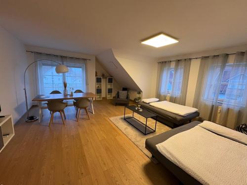 a living room with a bed and a dining table at Großzügiges Design-Loft in Aulendorf in Aulendorf