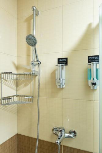 a bathroom with a shower with a shower head at Apartman Bn Vlasic in Vlasic