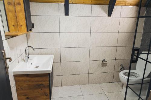 a bathroom with a sink and a toilet at Palm Garden in Korucuk