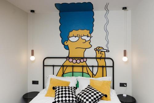 a bedroom with a wall mural of a man with a headboard at Stilinga studija su visais patogumais in Šiauliai