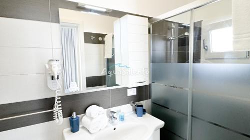 a bathroom with a sink and a shower at AQUARAMA Rooms & Apartments in Torre Squillace