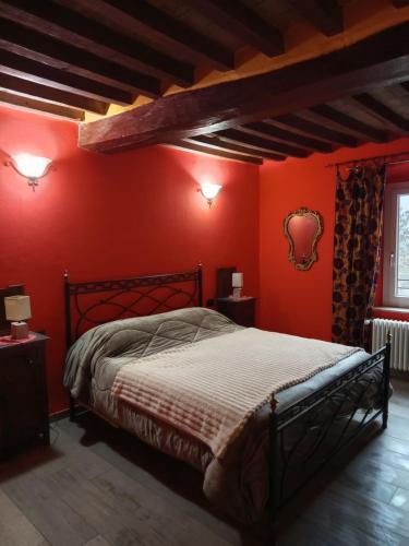 a bedroom with red walls and a large bed at B&BLe Tre Gemme in Montechiarugolo