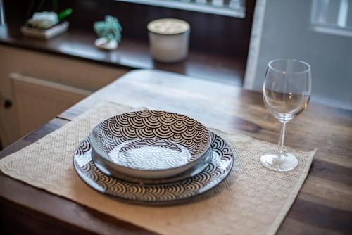 a bowl and a plate on a table with a glass at Lara Mezonet Tatry in Veľká Lomnica