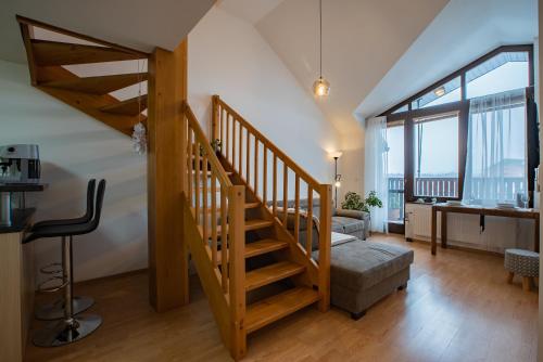 a staircase in a living room with a stair case at Lara Mezonet Tatry in Veľká Lomnica