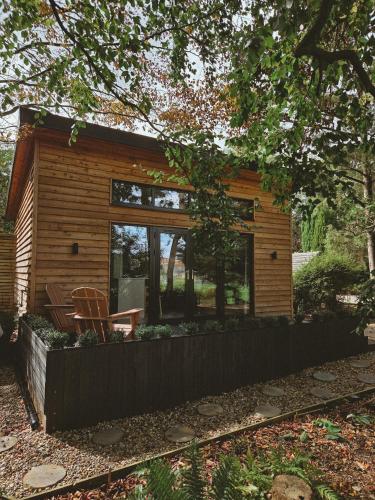 a small log cabin with a large window at The Lodge Burniston in Scarborough