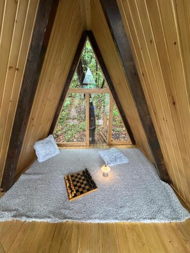 a bed in a room with a window at Vila na Vrhu in Rakovac