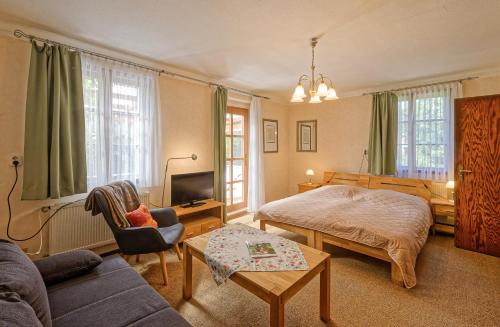a bedroom with a bed and a living room at Pension Maria am Schlosspark in Gotha