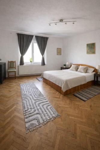 a bedroom with a large bed and a rug at Casa Dalia 1 in Sighişoara