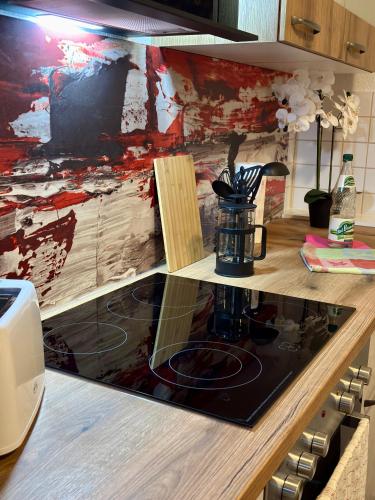 a kitchen with a counter top with a coffee maker at Macabu Apartment Porto in Plauen