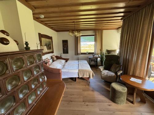 a bedroom with a bed and a living room at Ferienhaus Sonnhügel - Stissen in Faak am See