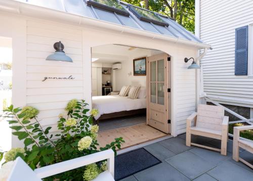 a small white cottage with a bed on a patio at sisu, a boutique motel in Plymouth