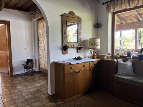 a kitchen with a counter and a mirror on the wall at Ferienhaus Sonnhügel - Stissen in Faak am See