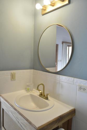 a bathroom with a sink and a mirror at Hooked on Panama Lodge in Limones
