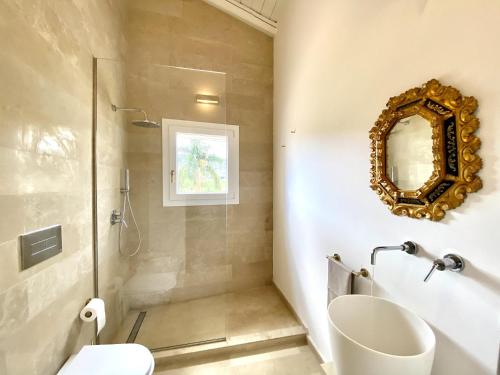 a bathroom with a shower and a sink and a mirror at Villa Nivara in Floridia