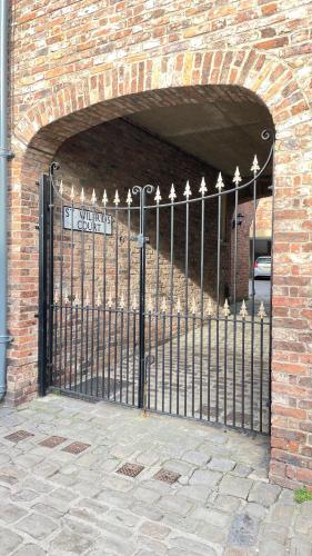 a gate in a brick building with an archway at St Wilfrid's Court in York