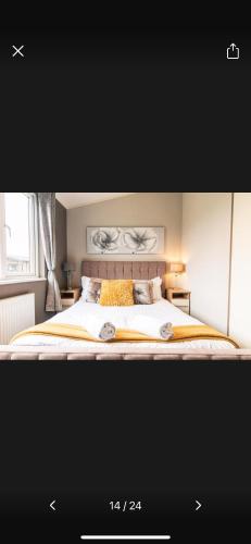 a bedroom with a large bed with at Lazy Days Lodge in Malton