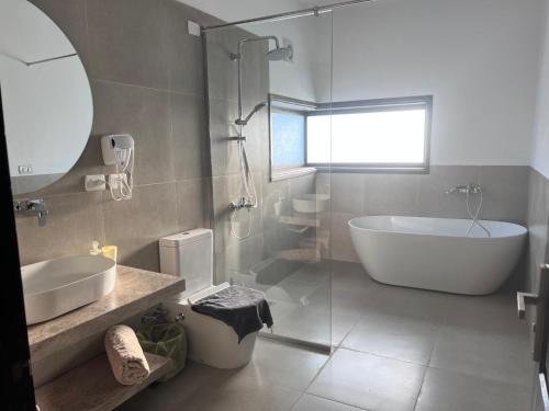 a bathroom with a tub and a sink and a bath tub at Villa Blanca Dahab in Dahab