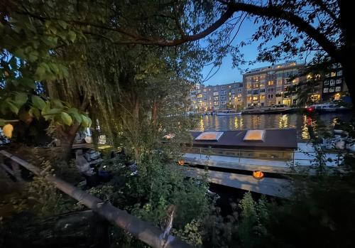 a boat on a river with buildings in the background at Cornelia Below Deck in Amsterdam
