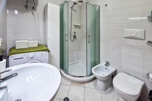 a bathroom with a shower and a toilet and a sink at Panorama Sky Apartment in Sarandë