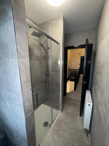 a bathroom with a shower and a walk in shower at Smithdown Hideaways in Liverpool