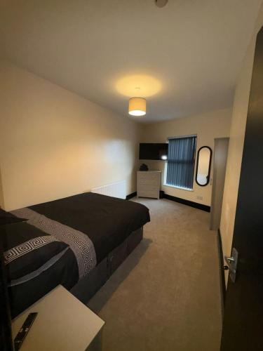 a hotel room with a bed and a window at Smithdown Hideaways in Liverpool