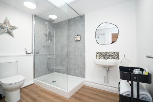 a bathroom with a shower and a toilet and a sink at Apartment ONE in Sherborne