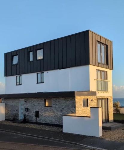 a building with a black roof on the side of a street at Bournemouth Beach & Sea Views in Bournemouth