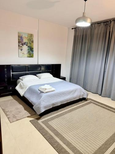 a bedroom with a large bed with a black headboard at Beauty Home Orestiada Center in Orestiada