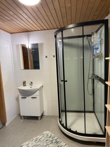 a bathroom with a shower and a sink at Saunallinen iso omakotitalo in Kotka