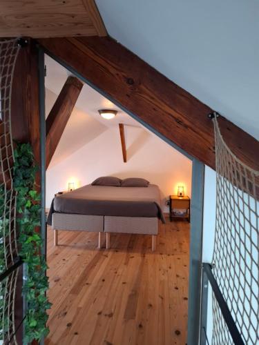 a bedroom with a bed in a attic at L'industriel - meublé de tourisme 4 étoiles in Fécamp