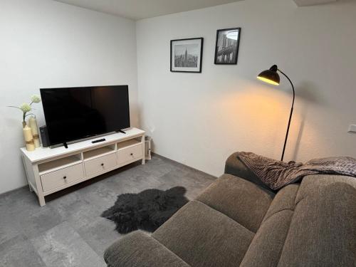 a living room with a couch and a flat screen tv at Ferienwohnung Meister in Mayen