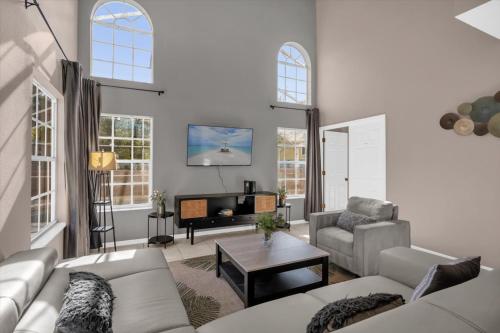 a living room with a couch and a table at Elegant Villa Pool Fun Game Room Near Disney in Kissimmee