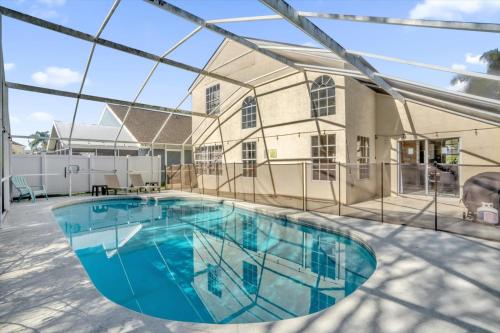 a swimming pool in front of a house at Elegant Villa Pool Fun Game Room Near Disney in Kissimmee