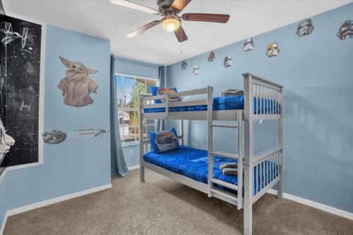 a bedroom with two bunk beds and a ceiling fan at Elegant Villa Pool Fun Game Room Near Disney in Kissimmee